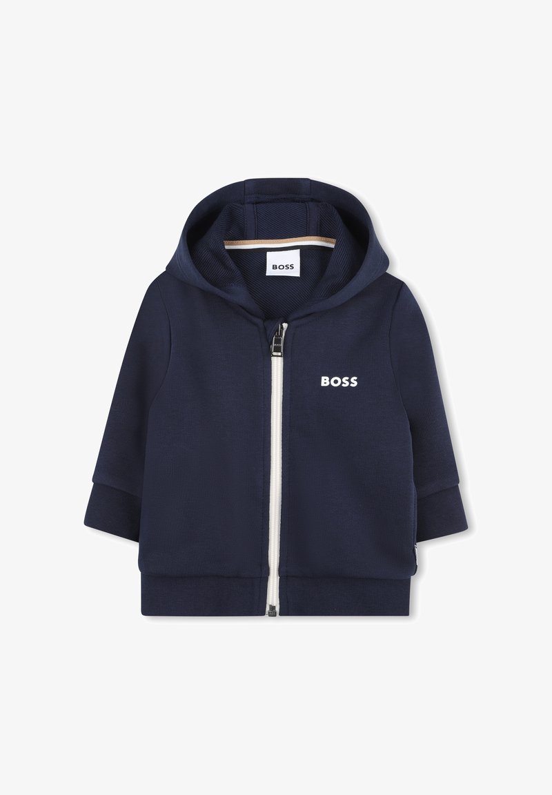 Hoodie zippé bleu marine en tissu texturé, avec une fermeture éclair blanche, des poignets côtelés et un logo sur la poitrine. Hoodie avec intérieur doublé.