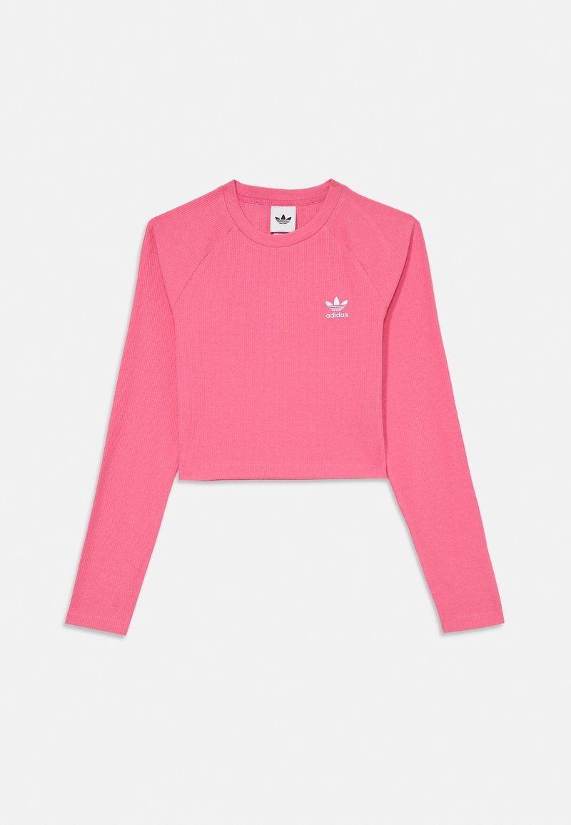 Pink, cropped long-sleeve top made from ribbed material. Features raglan sleeves and a white Adidas logo printed on the chest.