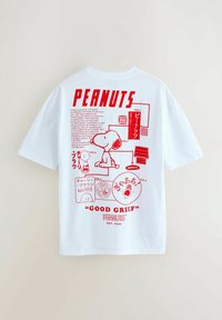 White cotton t-shirt featuring red graphic prints of Snoopy and text, including "PEANUTS" and "GOOD GRIEF," with various illustrations and details.
