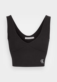 Svart ribbad kort topp med djup V-ringning, breda axelband och liten vit "cK" logotyp på nedre vänstra sidan.