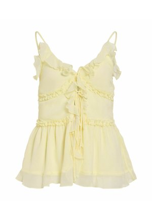 Blusa sin mangas de color amarillo claro con bordes con volantes, cierre con lazo delantero y dobladillo fluido y en capas.