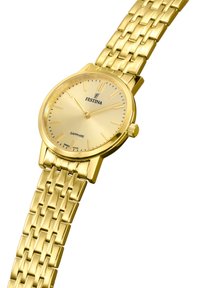 Reloj de pulsera dorado con esfera redonda y cristal de zafiro. Presenta una pulsera texturizada dorada y marcadores de horas minimalistas.