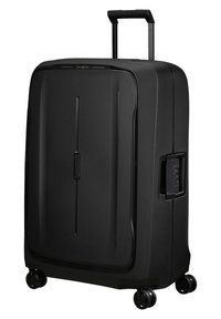 Black hard-shell suitcase with a smooth texture, vertical grooves, retractable handle, and four wheels for mobility. Features a combination lock.