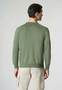 Maglione verde lavorato a maglia con polsini e orlo a coste, con un piccolo logo dettagliato sulla parte posteriore del collo. Texture liscia, vestibilità casual.