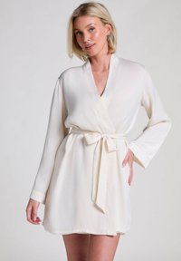 Cream-colored, silky robe with a wrap design, long sleeves, and a tie belt at the waist. Smooth texture and elegant finish.