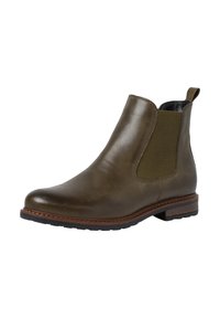 Botte Chelsea en cuir vert olive avec des panneaux élastiques sur les côtés, bout rond et finition texturée. Présente un petit talon empilé et une semelle en caoutchouc.