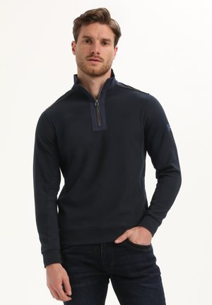 Marine sweatshirt met een halve ritssluiting, geribbelde textuur en accentpanelen aan de zijkant. Slank model met lange mouwen en een zachte afwerking.