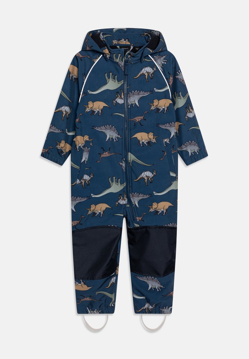 Fato de chuva com padrão de dinossauro azul, com mangas longas, fecho de correr e painéis de cor azul-marinho. Apresenta um capuz e laços para os pés para segurar o calçado.