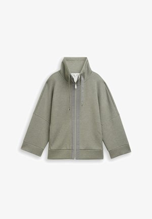 Veste zippée gris clair avec col montant, manches longues larges et cordons au niveau du col, présentée sur un fond blanc.