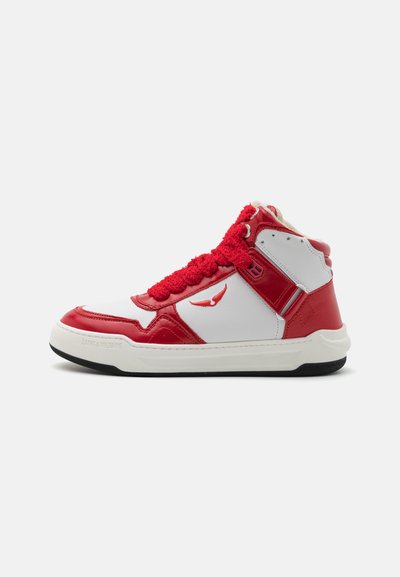 High-top sneaker with a white and red leather exterior, fuzzy red laces, smooth texture, and a black rubber sole. Branding on the side.