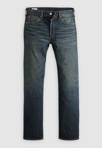Jean droit en denim bleu foncé avec zones décolorées, braguette à boutons, design à cinq poches et surpiqûres contrastantes, présenté sur un fond clair.