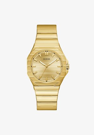 Guess armbåndsur i guldfarvet tone med rund urskive, stribet urskive, stiftsmarkører og matchende guldmetal armbåndsbånd.