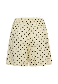 Shorts couleur crème avec des pois noirs et une taille élastique, présentés sur un fond blanc.