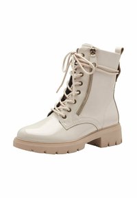 Lace-up ankle boots in glossy cream synthetic material. Chunky beige sole with tread, side zipper, and metallic eyelets.