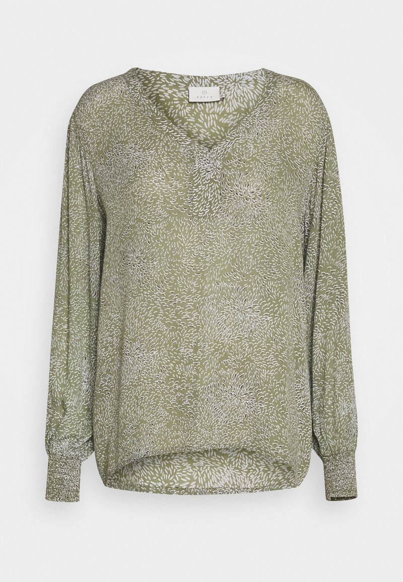 Blouse verte à manches longues avec un décolleté en V, ornée d'un motif floral blanc et de poignets élastiques. Fabriquée en tissu léger et texturé.