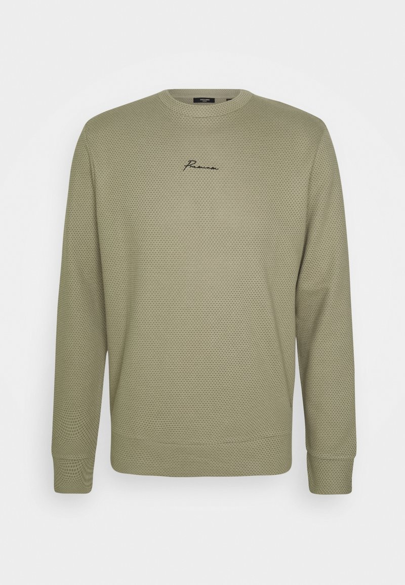 Sweat-shirt vert olive en tissu texturé façon nid d'abeille. Comprend un col rond et un logo brodé sur la poitrine. Manches longues.
