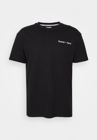 T-shirt en coton noir avec un col rond, des manches courtes et un petit logo blanc "Tommy Jeans" sur la zone gauche de la poitrine.
