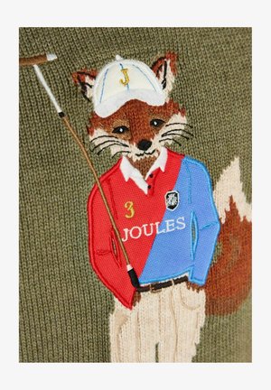 Knitted fox wearing a red and blue polo shirt with "Joules" text, beige pants, white cap with letter "J," holding a golf club on green background.