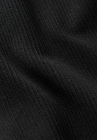 Gros plan sur un tissu noir côtelé avec une surface douce et texturée, et de subtiles lignes verticales créant des plis délicats.