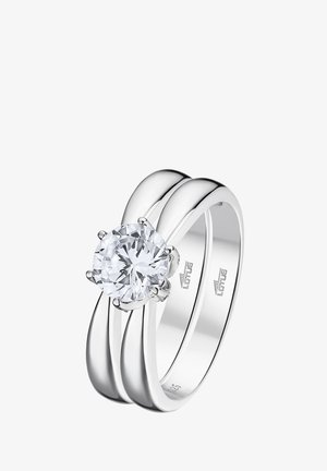 Silver engagement ring with a round, clear diamond centerpiece, featuring a smooth, polished band and intertwined double design.