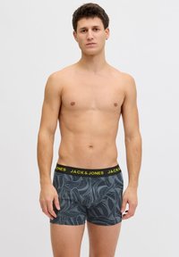 Ανδρικά μπόξερ σλιπ σε σκούρο γκρι με σχέδιο φύλλου, με μαύρη μέση και κίτρινο λογότυπο της μάρκας. Ελαστικό ύφασμα με στενή εφαρμογή.