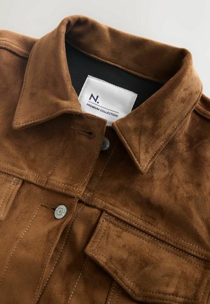 Brown suede jacket with a classic collar, visible stitching, and silver hardware. Label reads "N. Premium Collection."