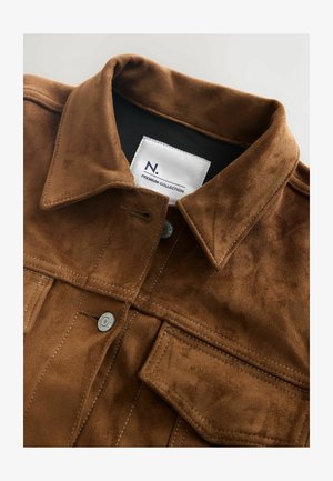 Barna velúr dzseki klasszikus gallérral, látható varrással és ezüst színű fém kiegészítőkkel. A címke szerint: "N. Premium Collection."