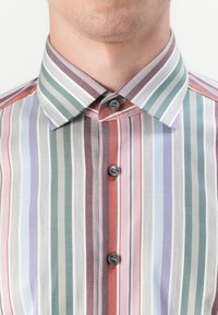 Striped shirt featuring a mix of colors: purple, green, red, and gray. It has a pointed collar and two dark buttons along the front.