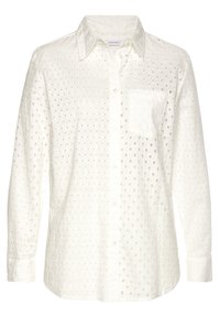 Camicia bianca con bottoni realizzata in tessuto testurizzato, caratterizzata da pois ricamati, tasca frontale e maniche lunghe con polsini abbottonati.
