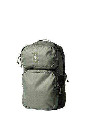 Green backpack with two front zippered compartments and a small logo patch on the upper pocket against a white background.