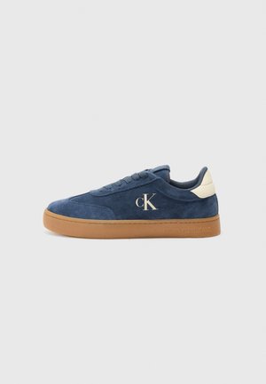 Sneakers blu in suede con suola in gomma color beige, caratterizzati da un accento bianco sul tallone e logo CK ricamato di lato.