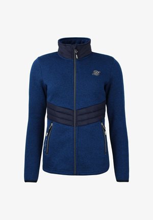 Giacca in pile blu navy con collare alto, chiusura con zip e pannello imbottito sul petto. Presenta tasche laterali con hardware argento e dettaglio del logo.