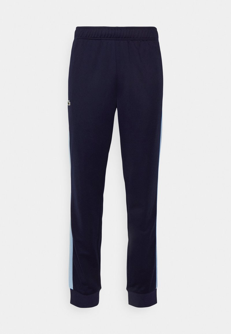 Navyblaue Jogginghose aus weichem Material, mit hellblauen seitlichen Streifen und einem elastischen Bund mit gerippten Bündchen an den Knöcheln.