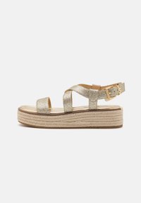 Gold glitter wedge sandals with cross straps, an adjustable ankle buckle, and a braided jute platform sole. Smooth interior lining.