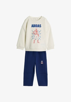 Cream sweatshirt with blue "ADIDAS" text and red Spider-Man graphic, paired with navy blue pants featuring Adidas and Marvel logos.