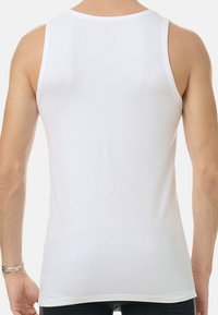 Vit linne med en mjuk bomullstextur, klassisk ärmlös design, rund halsringning och en åtsittande silhuett utan utsmyckningar.