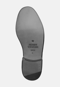 Sohle eines Anzugschuhs mit der Prägung "Henry Stevens Berlin 8", ausgestattet mit einer glatten Oberfläche und einem verstärkten Absatz mit sichtbaren Nägeln.