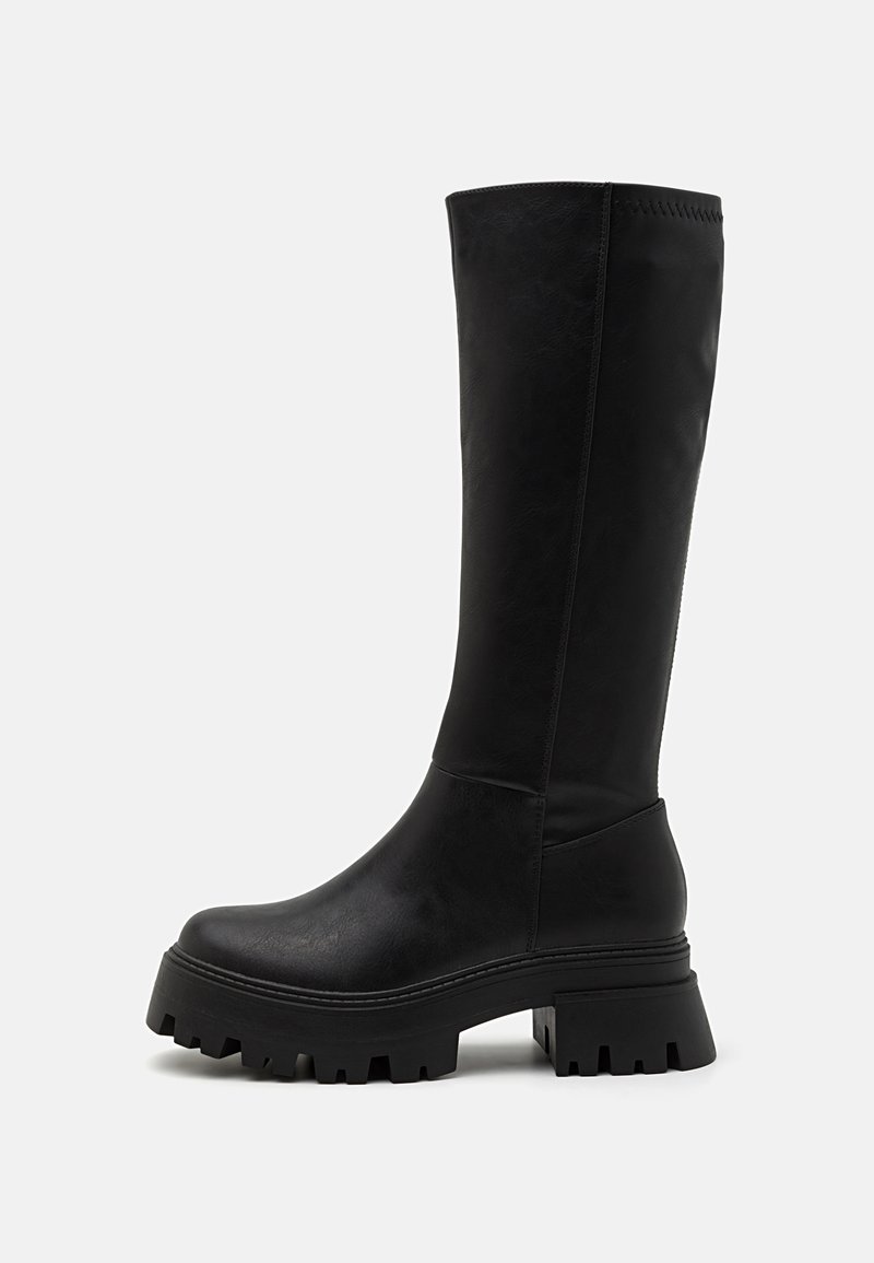 Black knee-high boots made of faux leather, featuring a chunky rubber sole with deep grooves, smooth surface, and minimal stitching details.