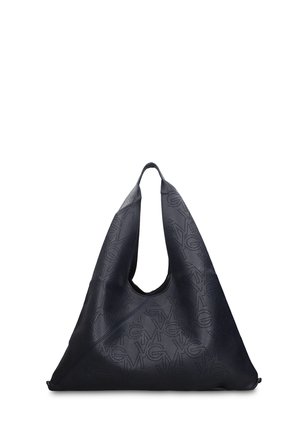 Borsa a mano triangolare in pelle nera con motivo geometrico traforato e ampi manici superiori, esposta su uno sfondo bianco.