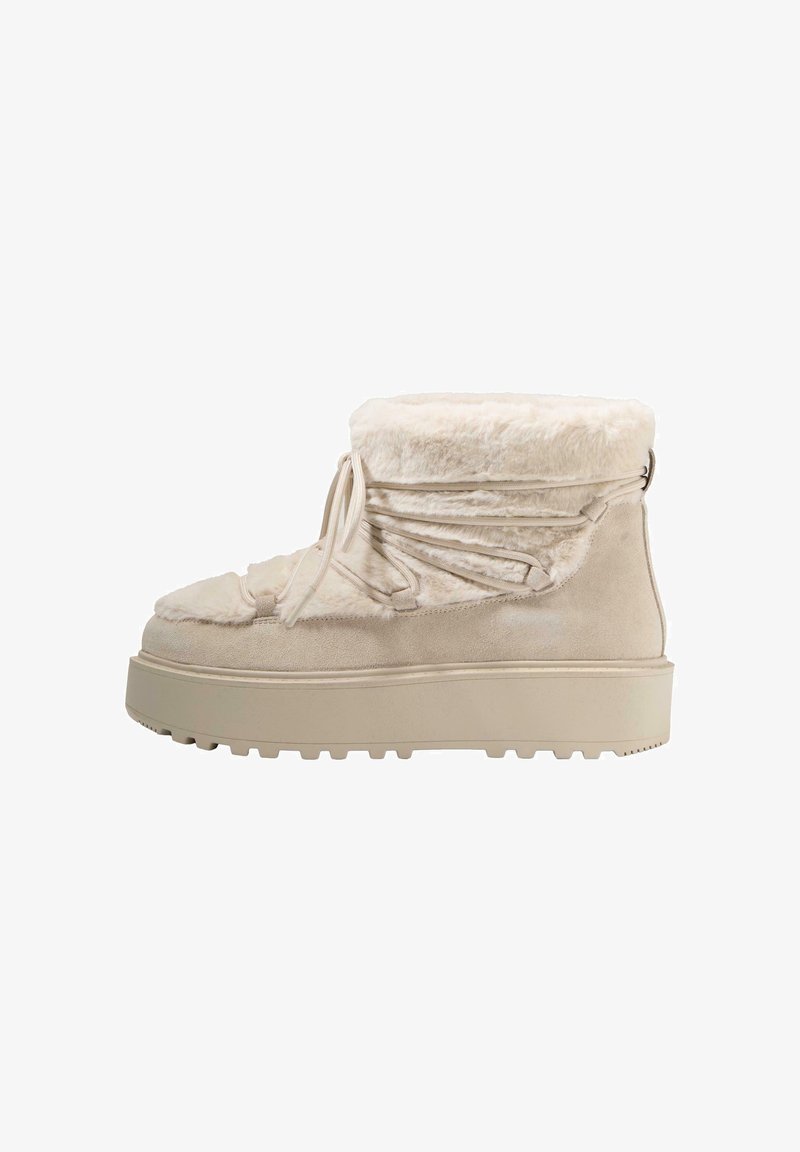 Beige winter boots with a plush fur lining, suede exterior, and a thick textured sole. Features a gathered design and adjustable laces.