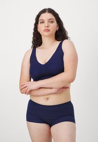 Navy blue, seamless soft bra and boyshort set made from stretch fabric, featuring a deep V-neck and wide straps for comfort.