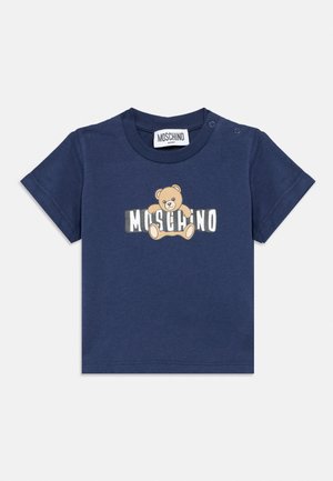 Navy blue baby T-shirt with a teddy bear graphic and "Moschino" text across the chest, featuring snap buttons on the shoulder.