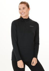 Svart långärmad topp med kvartdragkedja, som har en mjuk textur och en figurnära design. Inkluderar en liten logotyp på bröstet.