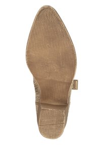Suela de zapato de tacón beige con patrón texturizado, leve curva en la punta, tacón plano y acabado suave, que presenta un diseño minimalista.