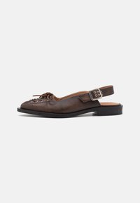 Brown leather slingback shoe with rounded toe, lace-up front, and a buckle closure on the strap. Flat sole with minimal tread.
