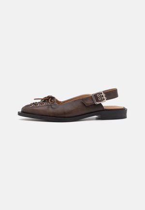 Brown leather slingback shoe with rounded toe, lace-up front, and a buckle closure on the strap. Flat sole with minimal tread.