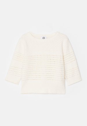 Pulover ușor din crem, cu mâneci trei sferturi, având un model texturat și un tiv cu nervuri. Design simplu cu accente de tricotaj deschis.