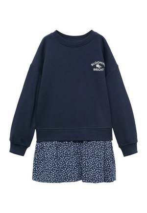 Marineblå langærmet sweatshirt med teksten "Blooming Bright" og lille blomster grafik over et marineblåt blomsterprintet skørt.