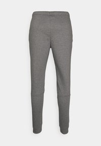 Graue Sweatpants aus weichem Material, mit einem gerippten Bund, schmal zulaufenden Beinen und enganliegenden Bündchen an den Knöcheln.
