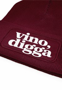 Burgundy knit beanie with a textured surface and a large white embroidered patch that reads "vino', diggà."